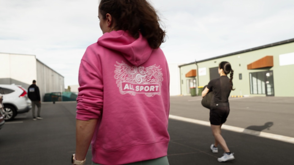 A player in an AllSport hoodie watches a sprint